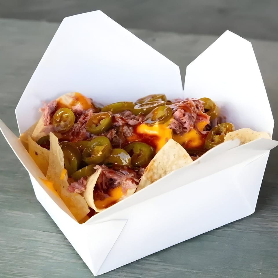 Mosito's BBQ nachos with pulled pork, melted cheese, jalapeños, and BBQ sauce in a white container.